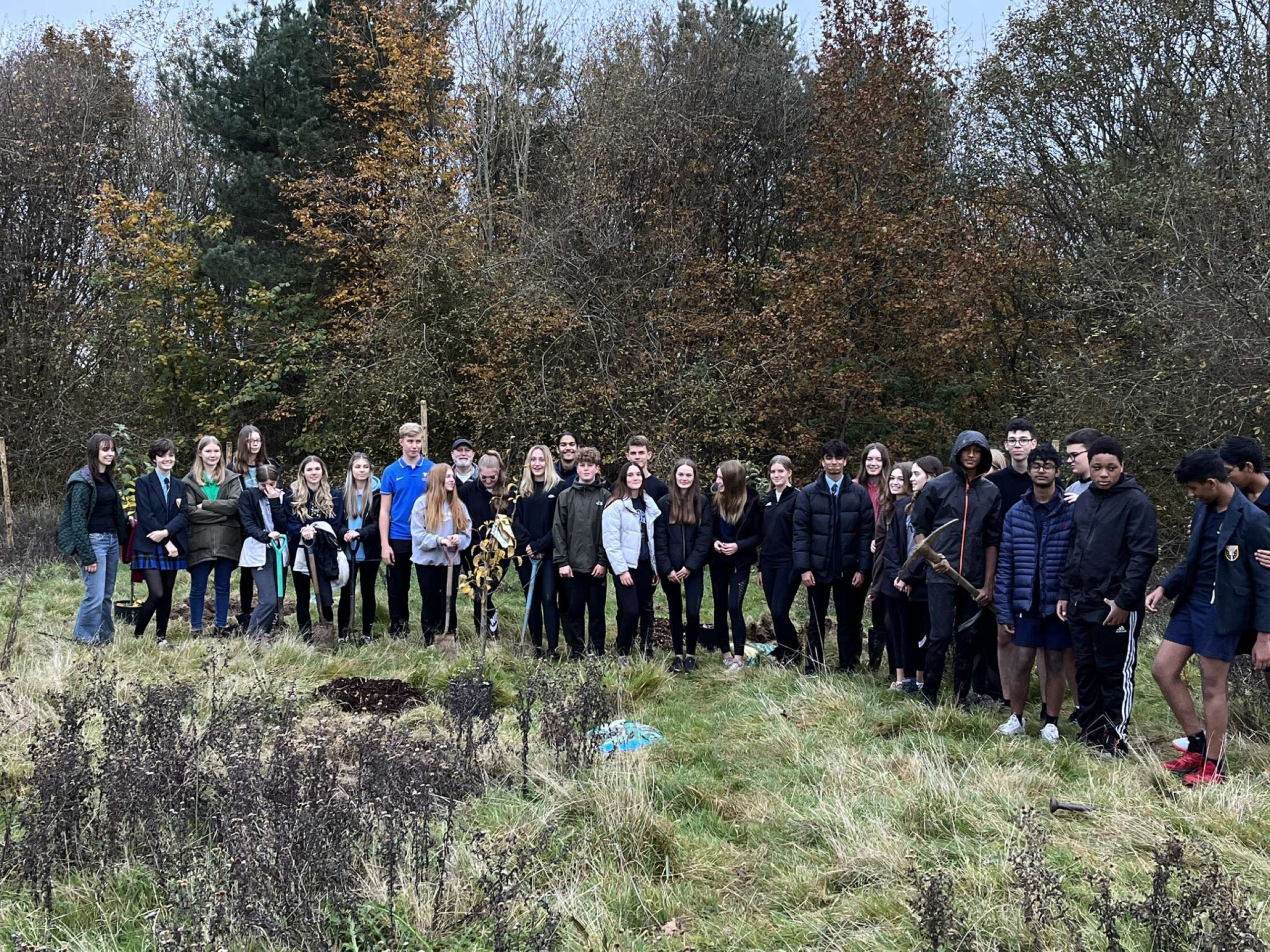 Warden Park Secondary Academy students, staff and sponsors plant fruit  trees, limes, beaches and birch trees on the school grounds from money raised by TreeAction fundraiser.